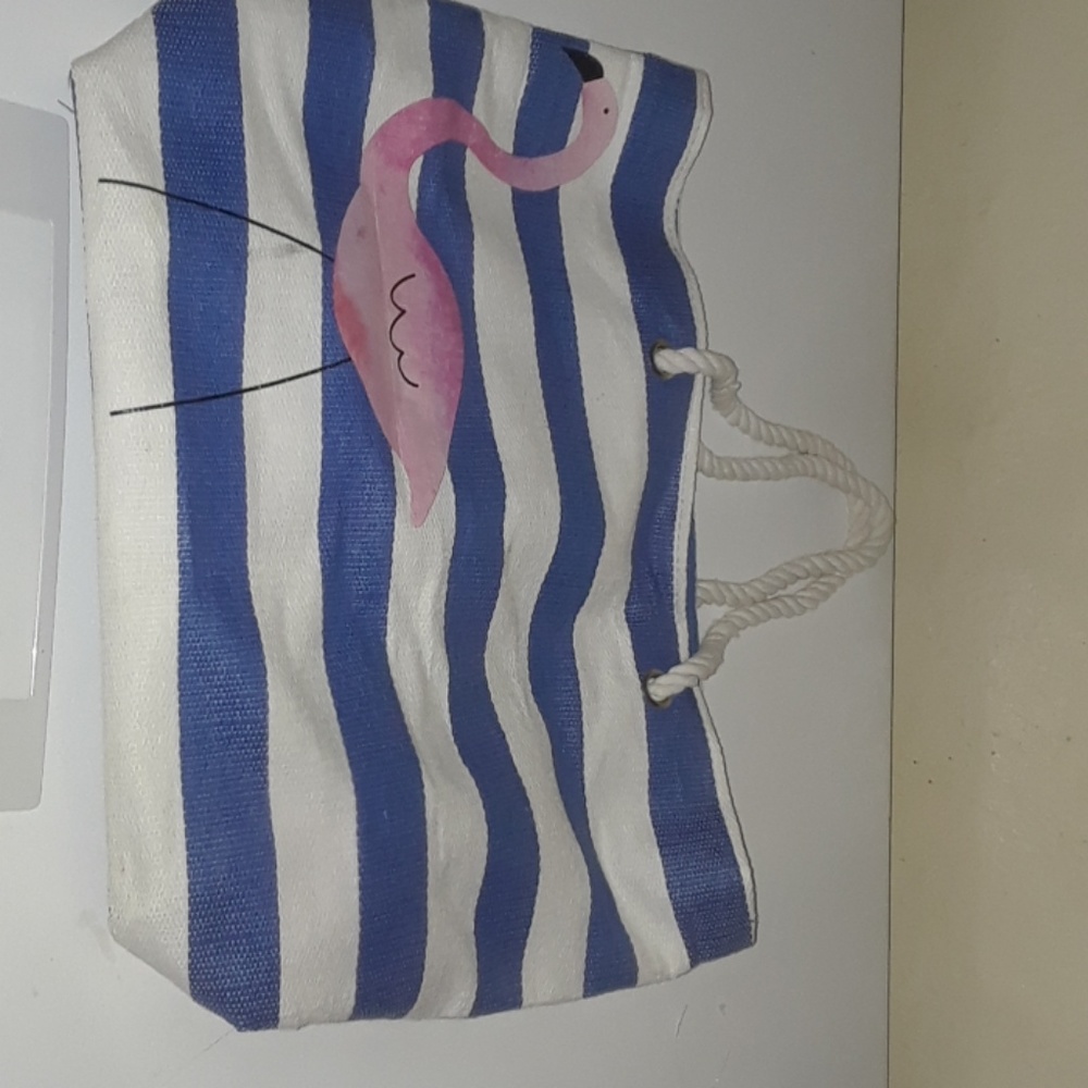Blue and white beach tote bag with a pink flamingo